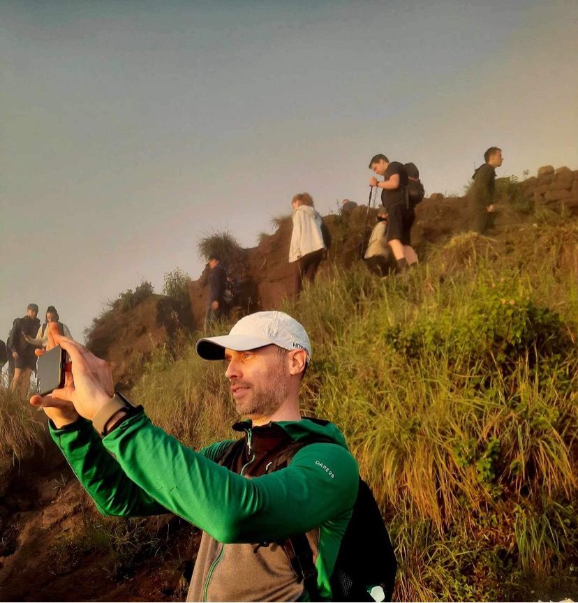 Rob taking a photo on a hike